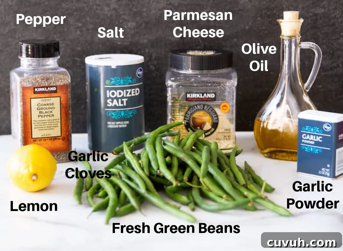 Fresh green beans, olive oil, garlic and garlic powder on a counter with salt and pepper. 