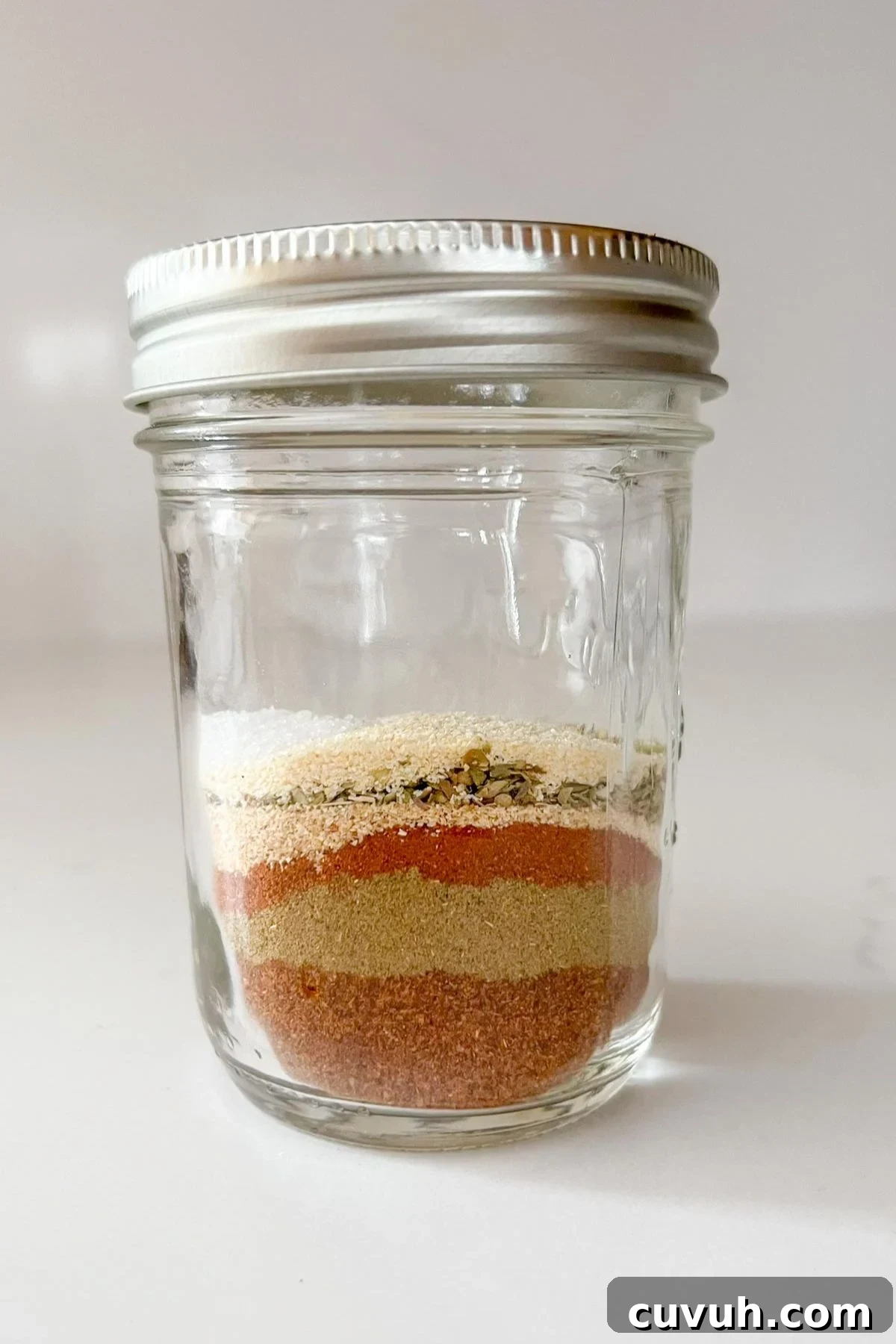 Clean-Eating Taco Seasoning Mix for Flavorful Homemade Tacos 4 Single spices needed for clean eating taco seasoning layered in a mason jar before being mixed.