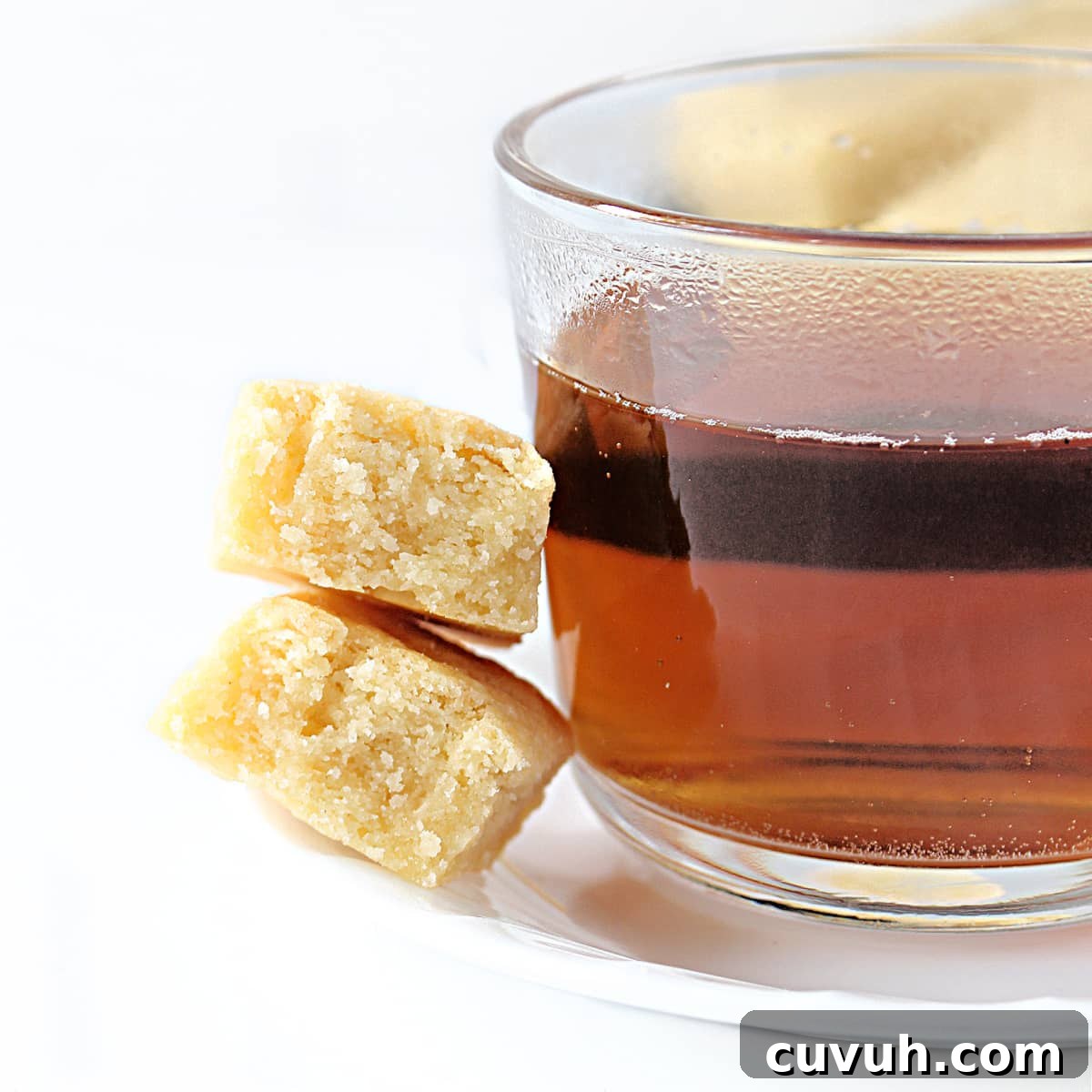 Tea cup with shortbread cookies on the side, showing interior buttery crumb.