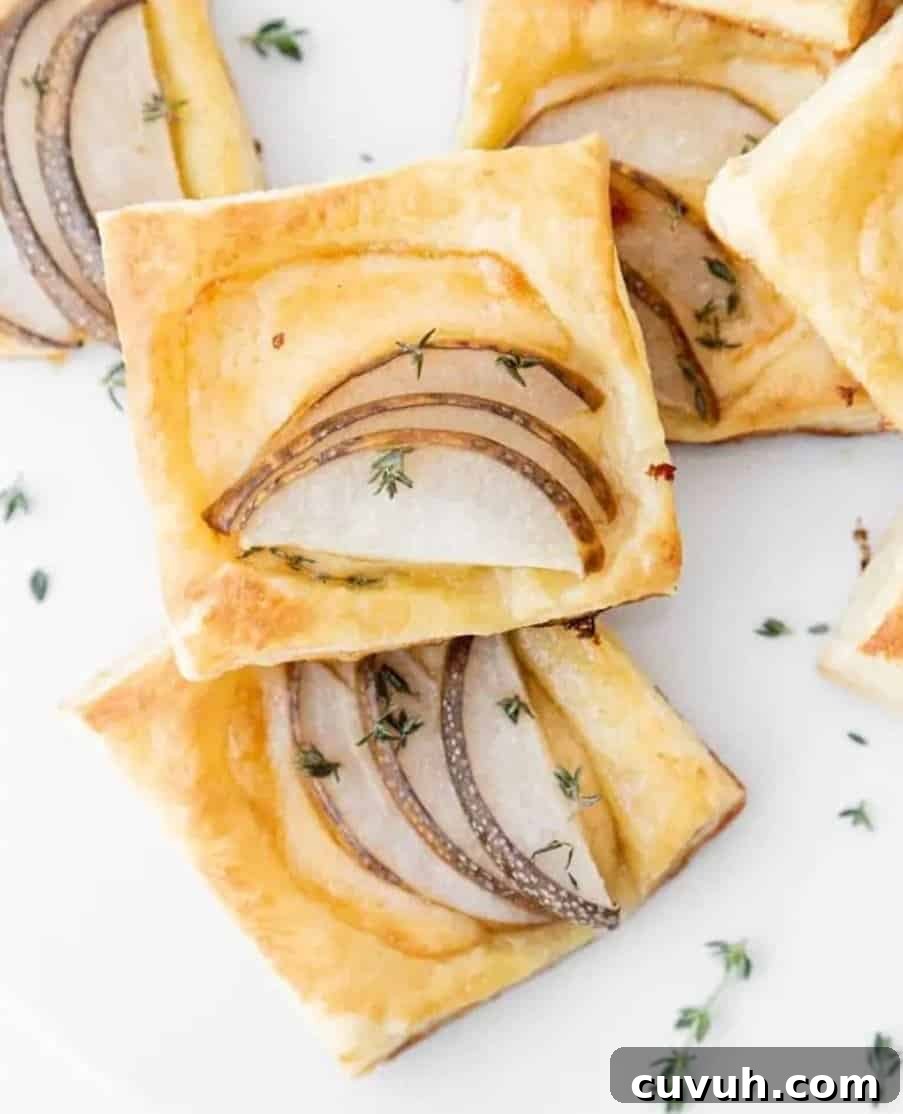 Thanksgiving Appetizers You Can Make Ahead for Stress-Free Hosting 10 Puffed pastry with pear on a white counter.