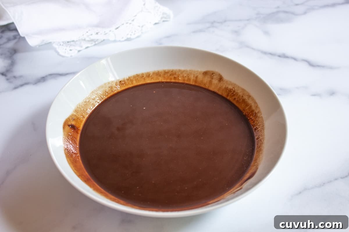 Melted chocolate in a white bowl.