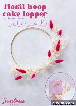 A gold hoop decorated with pink and cream flowers and leaves.