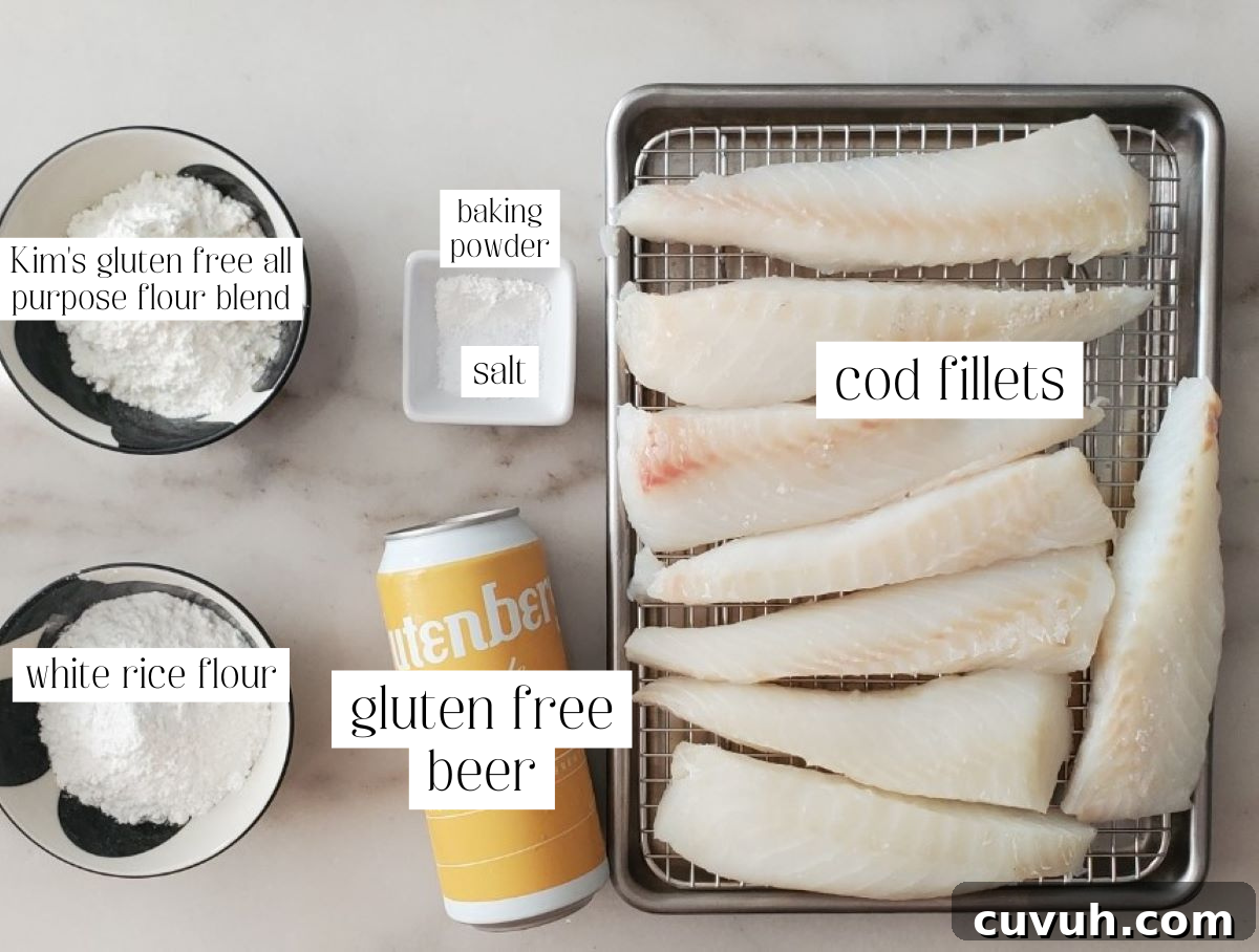 ingredients for fish and chips measured out and labeled on white marble counter.