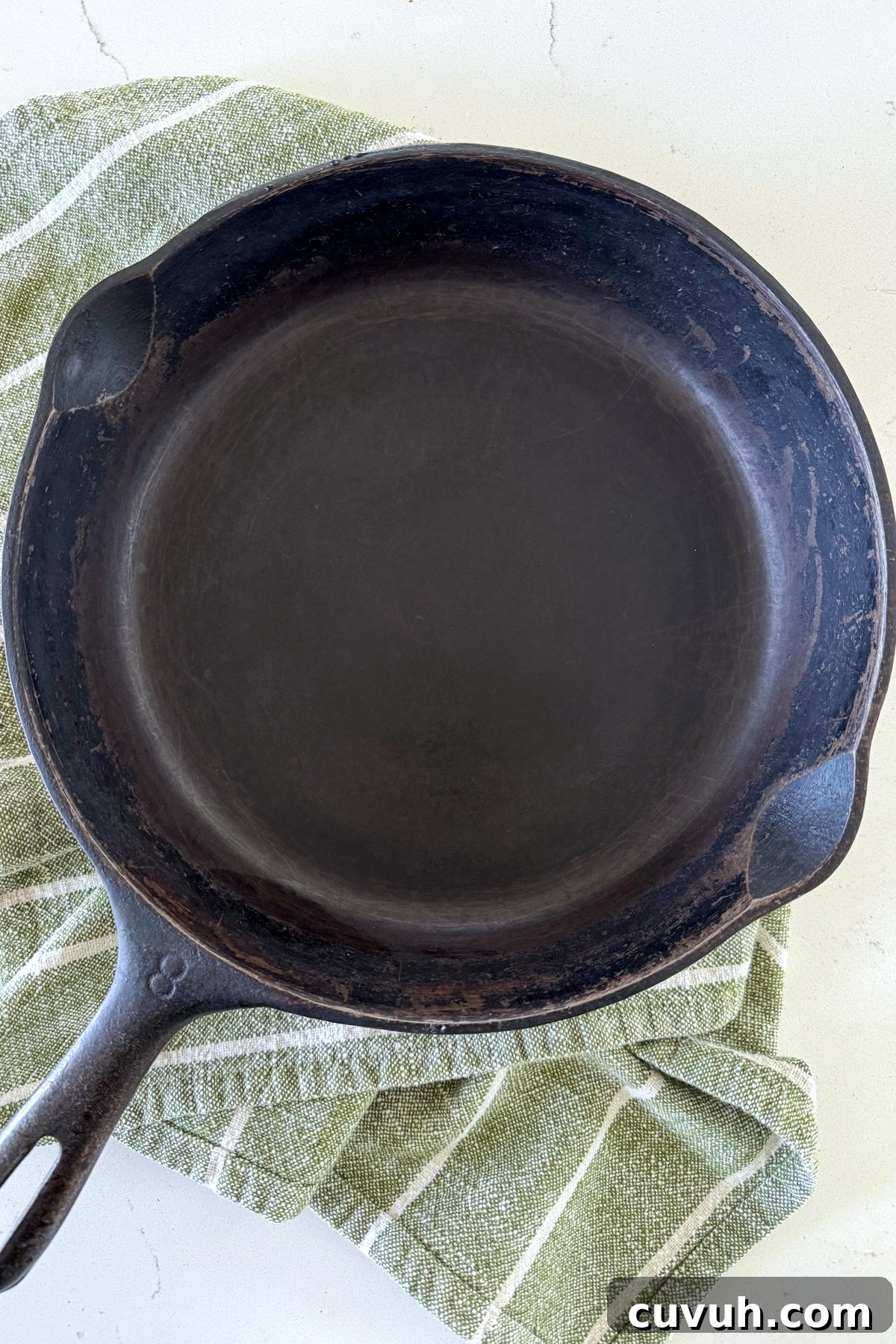 How to Clean and Care for a Cast Iron Skillet: Tips for Lasting Seasoning 11 clean cast iron pan on green towel
