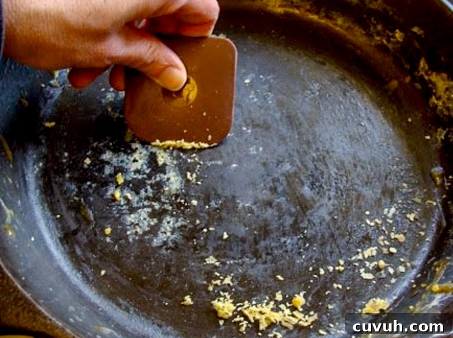How to Clean and Care for a Cast Iron Skillet: Tips for Lasting Seasoning 6 using plastic scrubber to remove bits from skillet