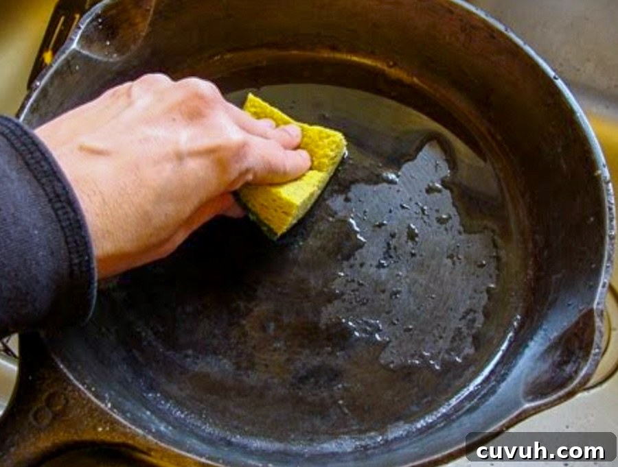 How to Clean and Care for a Cast Iron Skillet: Tips for Lasting Seasoning 7 using a scrub sponge and water to wash skillet
