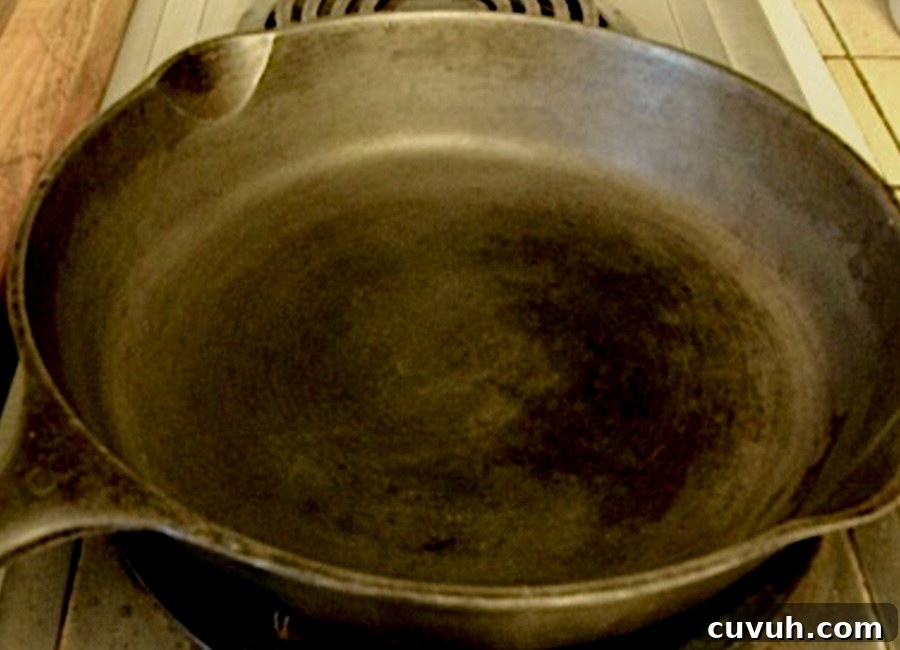 How to Clean and Care for a Cast Iron Skillet: Tips for Lasting Seasoning 8 drying cast iron skillet on stove