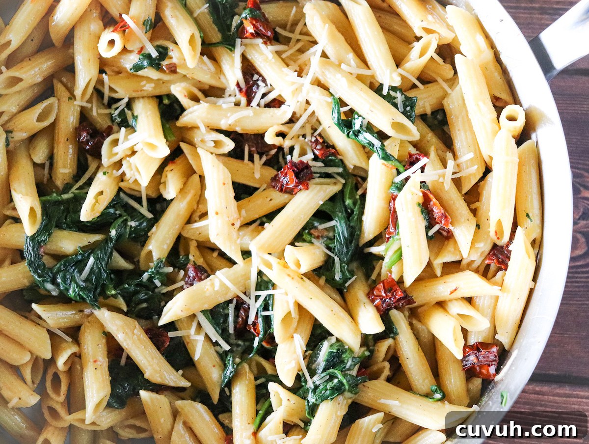 Protein Pasta with Sautéed Spinach and Sun-Dried Tomatoes 5 protein pasta topped with parmesan cheese