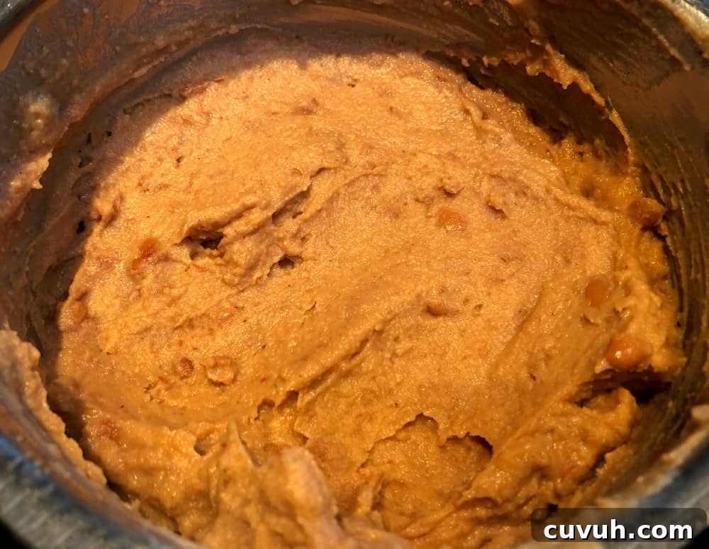 Copycat Taco Bell Mexican Pizza Recipe to Make at Home 4 refried beans in a pan.