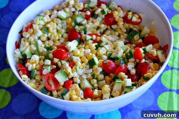 Fresh Corn, Zucchini and Tomato Salad Fresh Corn, Zucchini and Tomato Salad in a white bowl set on a blue and green polka dot tablecloth