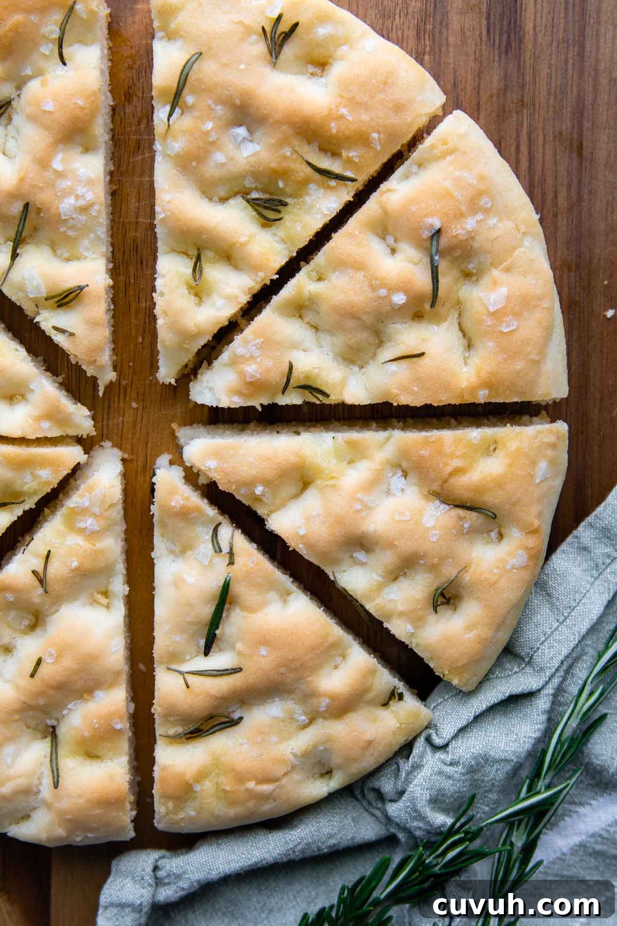 focaccia sliced in wedges on a wood cutting board