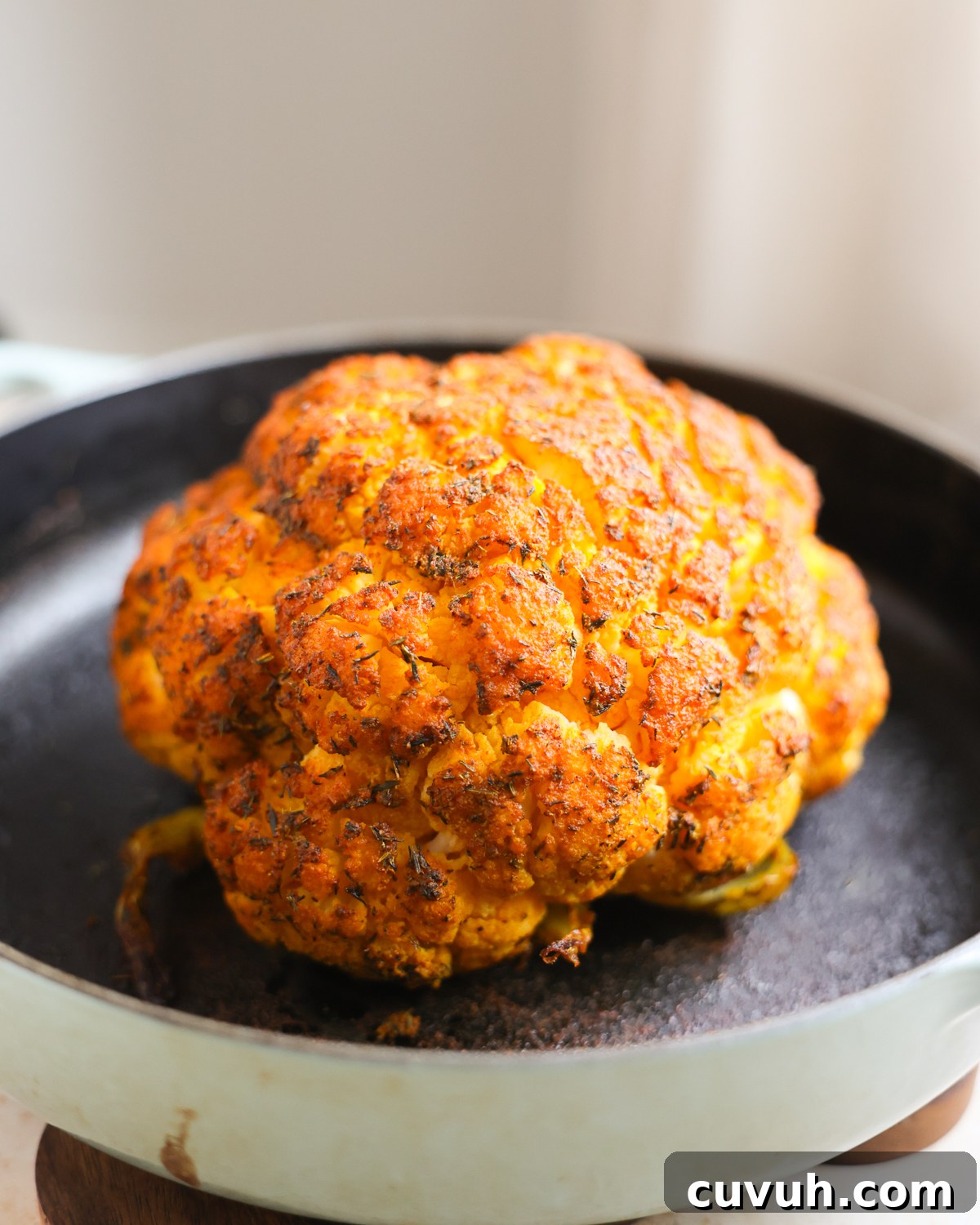whole roasted cauliflower in pan