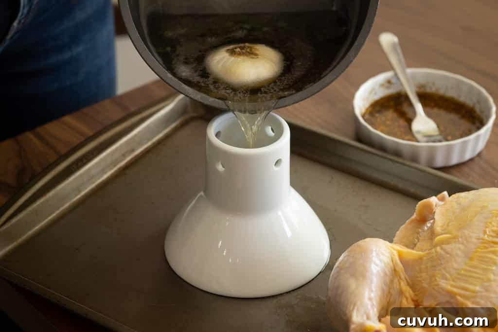 Crispy Grilled Beer-Can Chicken Recipe for Juicy Poultry 4 Boiled beer pouring into a beer can chicken roaster.