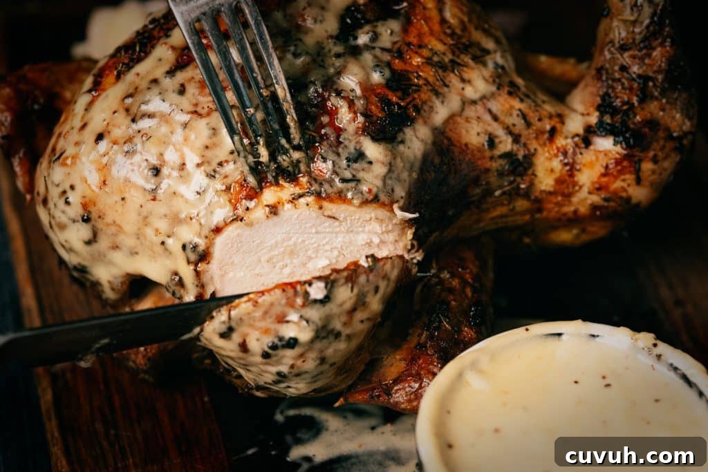 Crispy Grilled Beer-Can Chicken Recipe for Juicy Poultry 7 Beer can chicken covered in beer cheese being sliced.