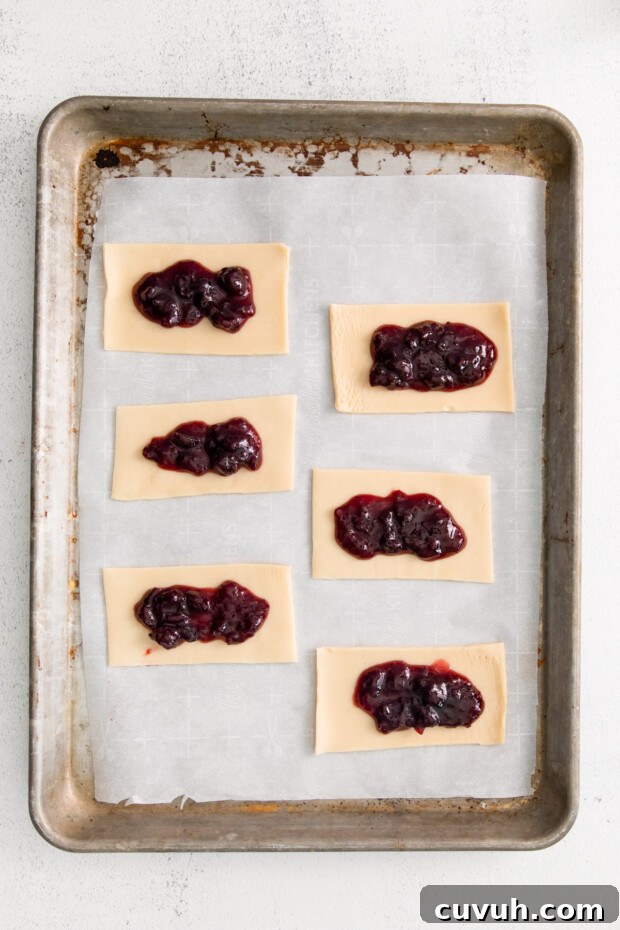 Crispy Air Fryer Pop-Tarts: Quick Homemade Toaster Pastry Recipe 5 Dough with jam in the middle.