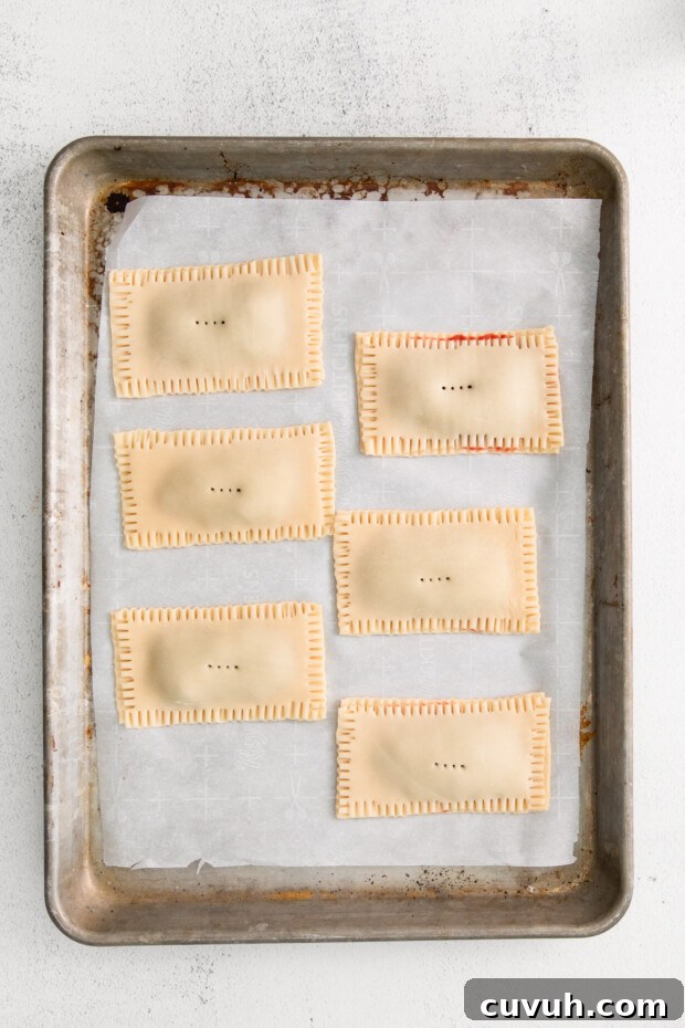 Crispy Air Fryer Pop-Tarts: Quick Homemade Toaster Pastry Recipe 6 Homemade pop tarts uncooked on parchment paper.