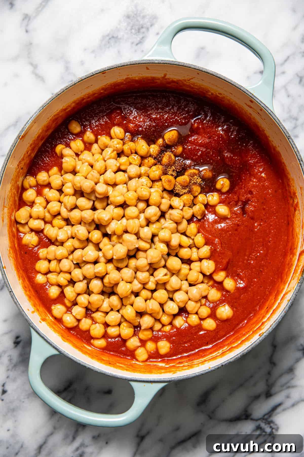 Chickpea Tikka Masala Recipe: Flavorful Vegan Curry in 30 Minutes 6 Chickpeas in a pan of tomato sauce.