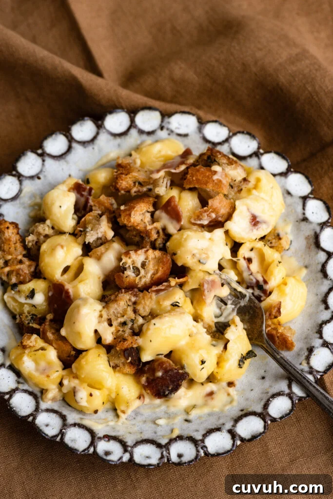 Creamy Baked Macaroni and Cheese Casserole 11 Mac and cheese casserole on a plate with a fork.