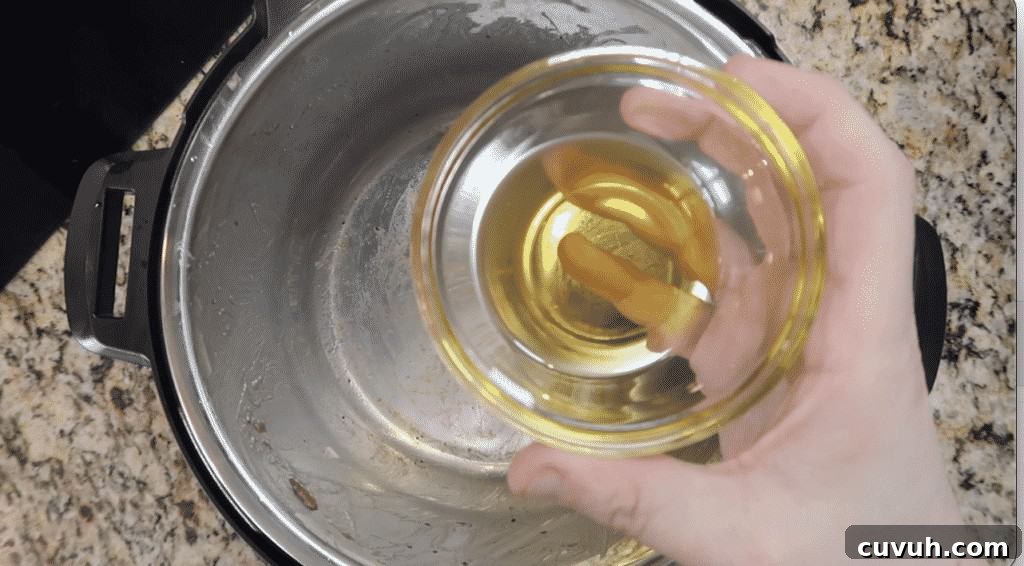 Adding olive oil to pot