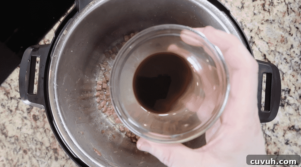 Adding Worcestershire sauce to pot
