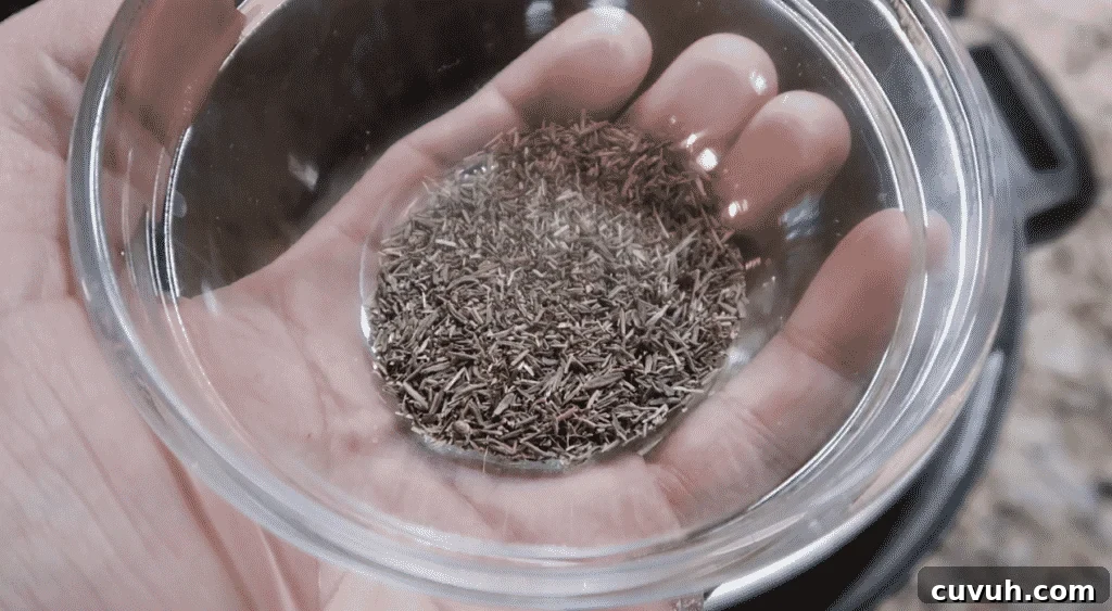 Adding dried thyme to pot.