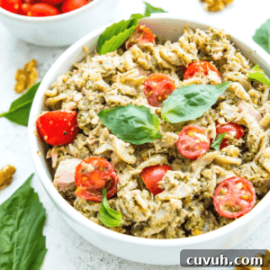 4-Ingredient Tuna Pesto Pasta Recipe – Ready in Minutes 13 A bowl of tuna pasta pesto topped with fresh basil.