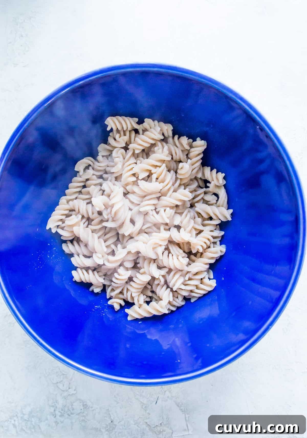 4-Ingredient Tuna Pesto Pasta Recipe – Ready in Minutes 5 A large bowl filled with cooked spiral noodles.