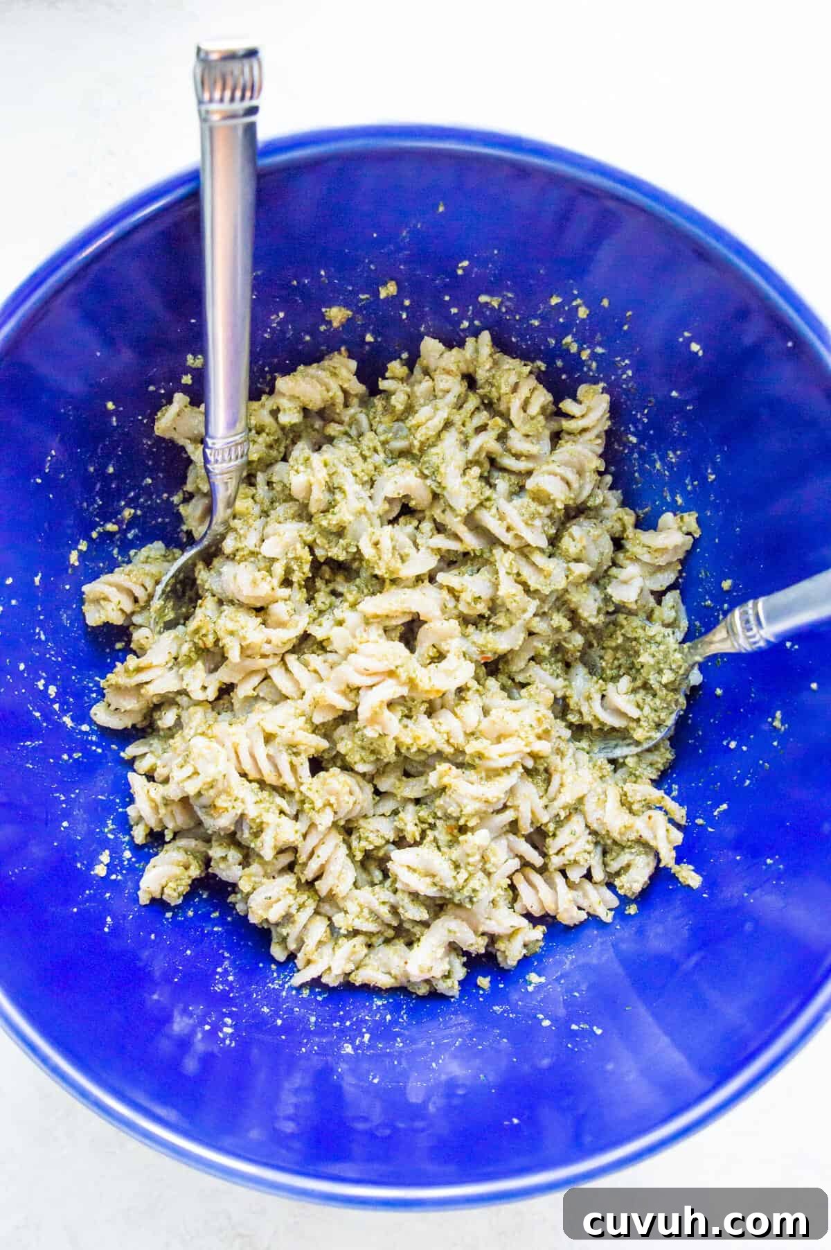 4-Ingredient Tuna Pesto Pasta Recipe – Ready in Minutes 6 A bowl of pasta noodles covered in pesto.
