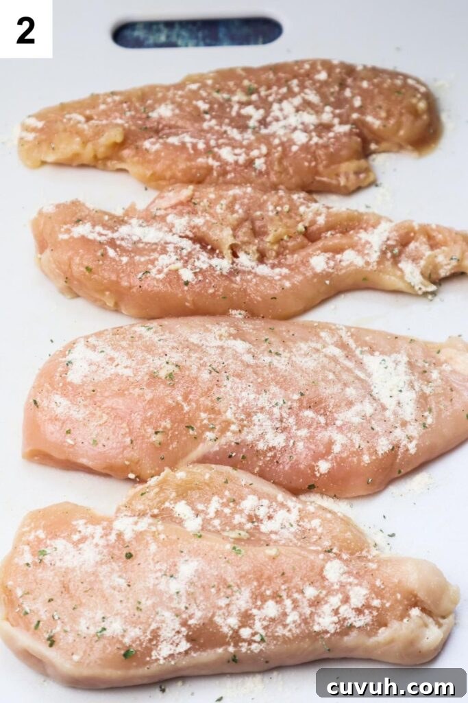 Smoked Gouda Chicken Bacon Ranch Sandwich Recipe 5 cutting board with chicken breasts seasoned with ranch seasoning