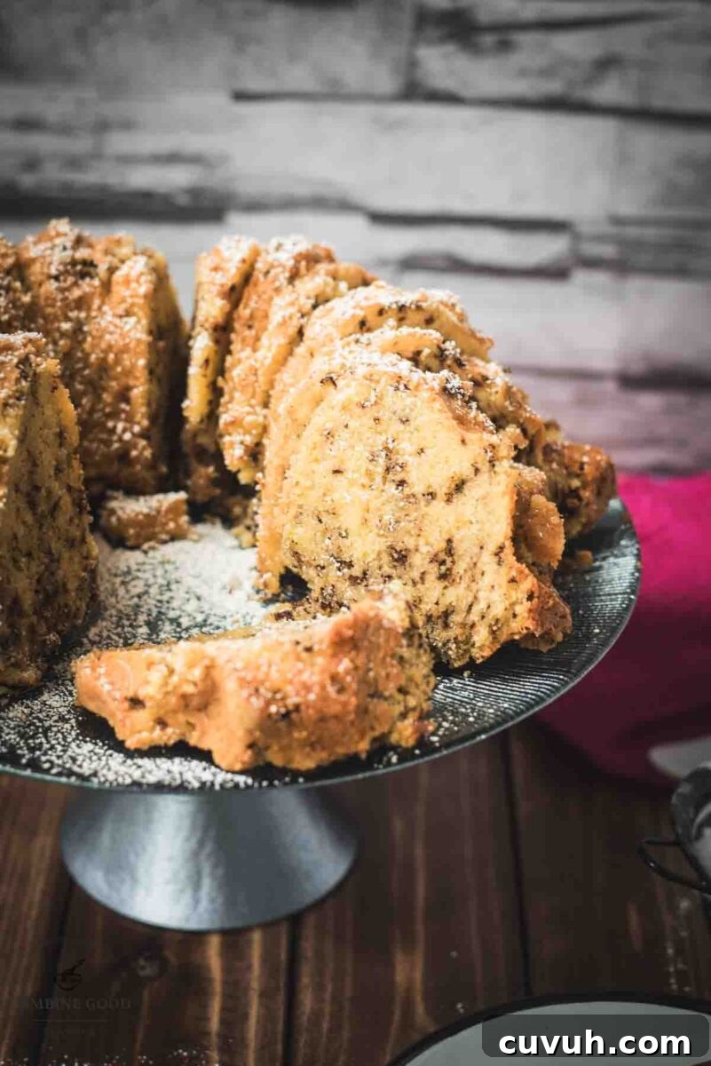 Delicious vanilla bundt cake with chocolate sprinkles, served on light blue cake stand.