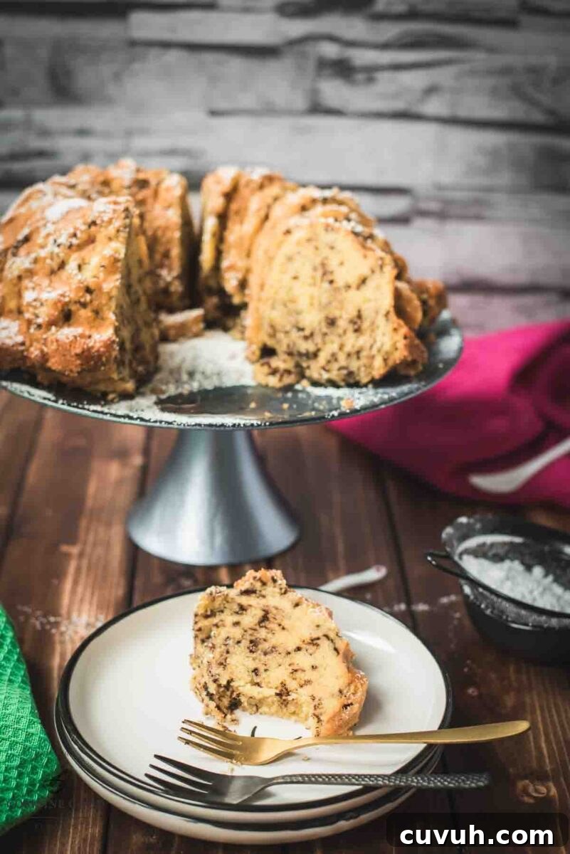 Delicious vanilla bundt cake with chocolate sprinkles, served on light blue cake stand.