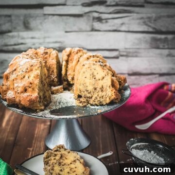 Delicious vanilla bundt cake with chocolate sprinkles, served on light blue cake stand.