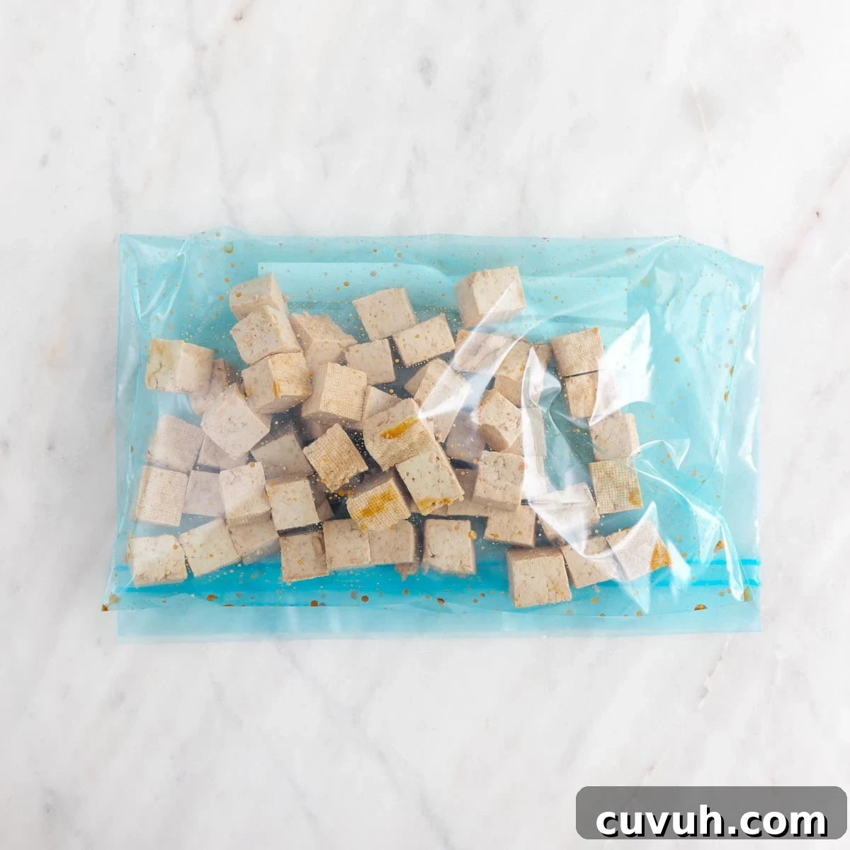 Sticky Teriyaki Tofu Bowl with Sesame and Scallions 5 Tofu cubes with soy sauce in a large ziplock bag.