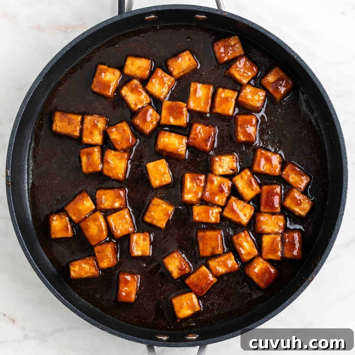 Sticky Teriyaki Tofu Bowl with Sesame and Scallions 9 Teriyaki tofu in a pan.