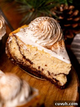 Slice of eggnog cheesecake on a wood platter.