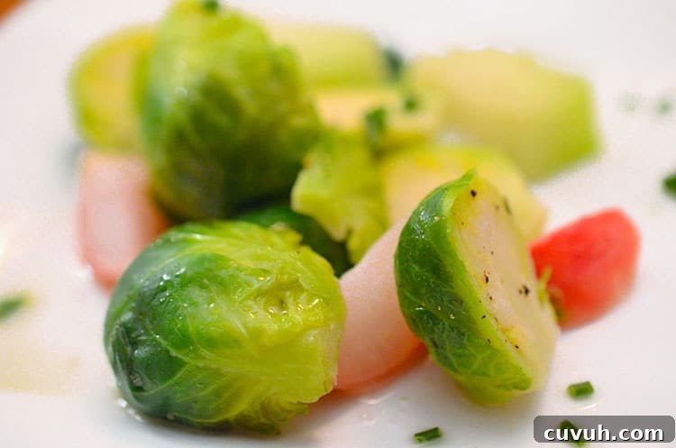 Slow-Braised Vegetables with Garlic and Herbs 2 A plate of food with Brussels sprouts