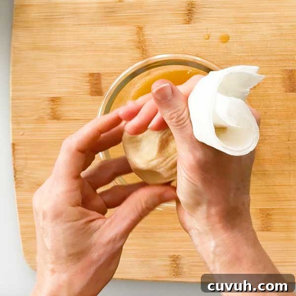Squeezing the water out of the pumpkin puree.