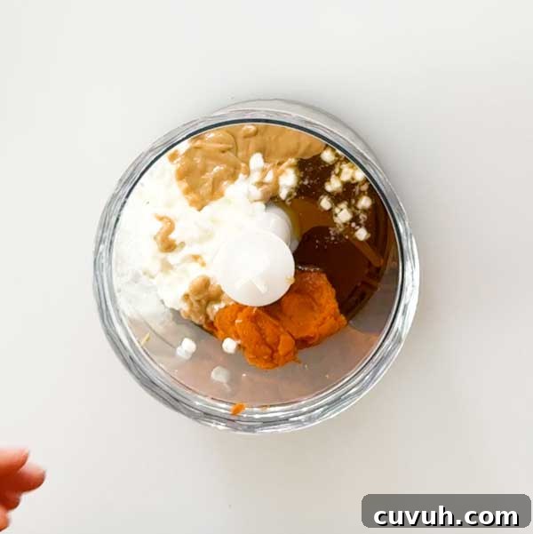 Adding all the wet ingredients to a chopper cup.