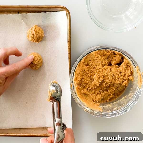 Scooping the truffles on the cookie sheet.