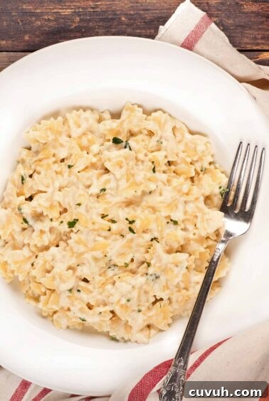A single serving of cottage cheese mac and cheese with fontina in a white bowl.