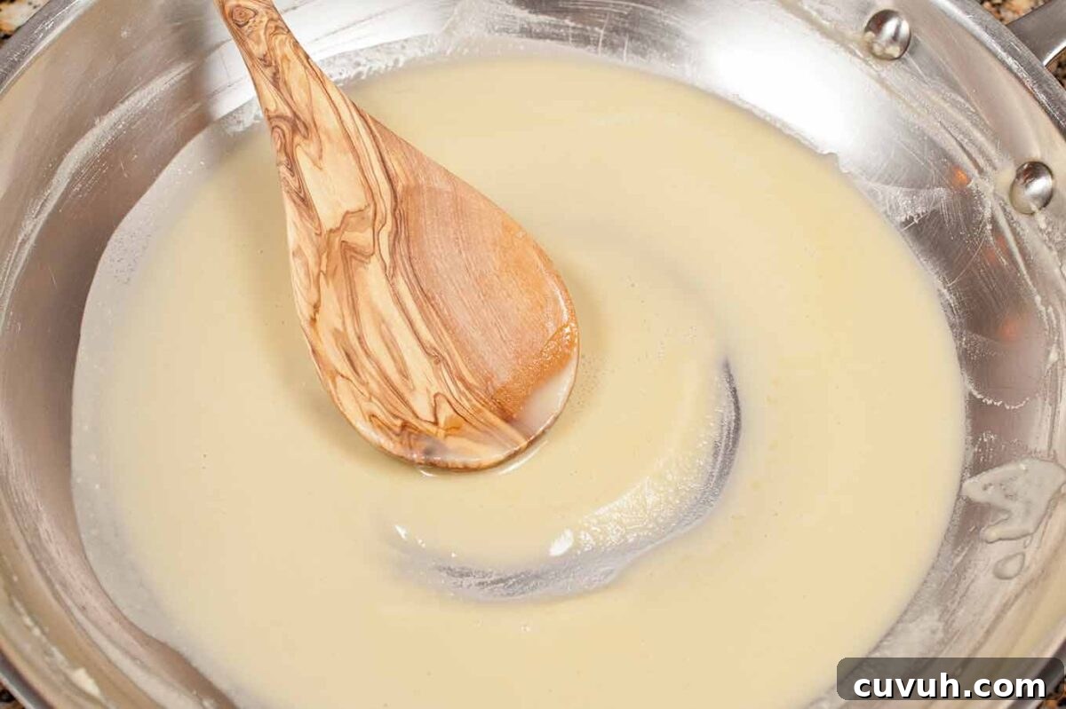 Smooth blond roux cooked for béchamel sauce in homemade macaroni and cheese.