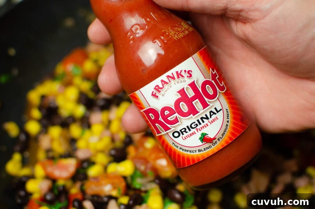 Brunch Nachos: Loaded Breakfast Nachos with Eggs & Avocado 5 A bottle of franks red hot sauce held by hand