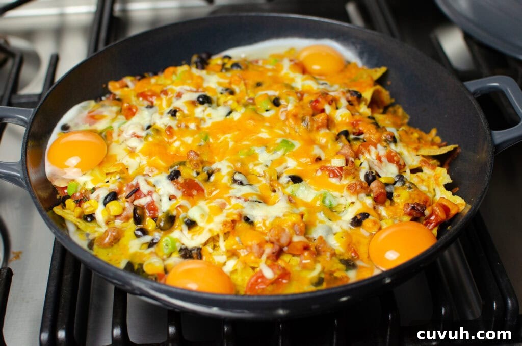 Brunch Nachos: Loaded Breakfast Nachos with Eggs & Avocado 10 Four cooked eggs on top of melted cheese on our breakfast brunch nachos in a cast iron pan