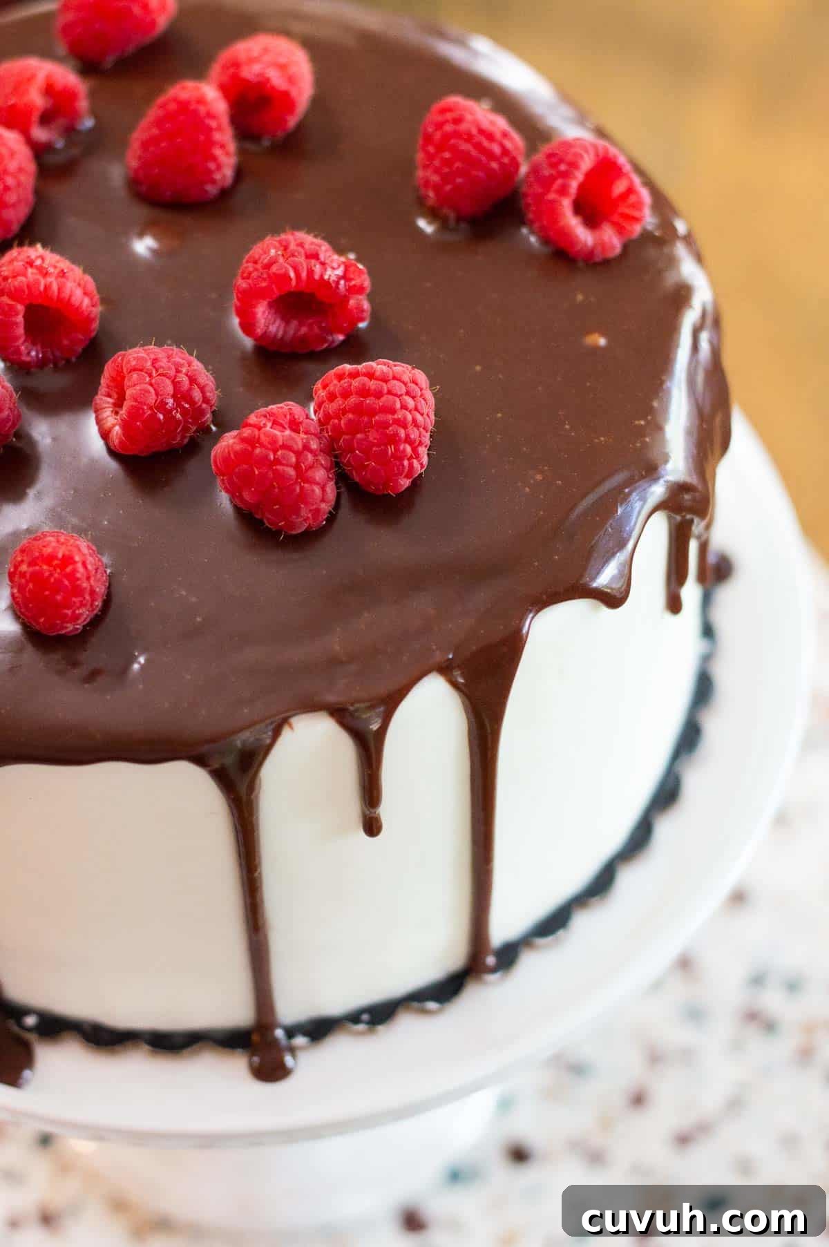 chocolate drip cake topped with raspberries
