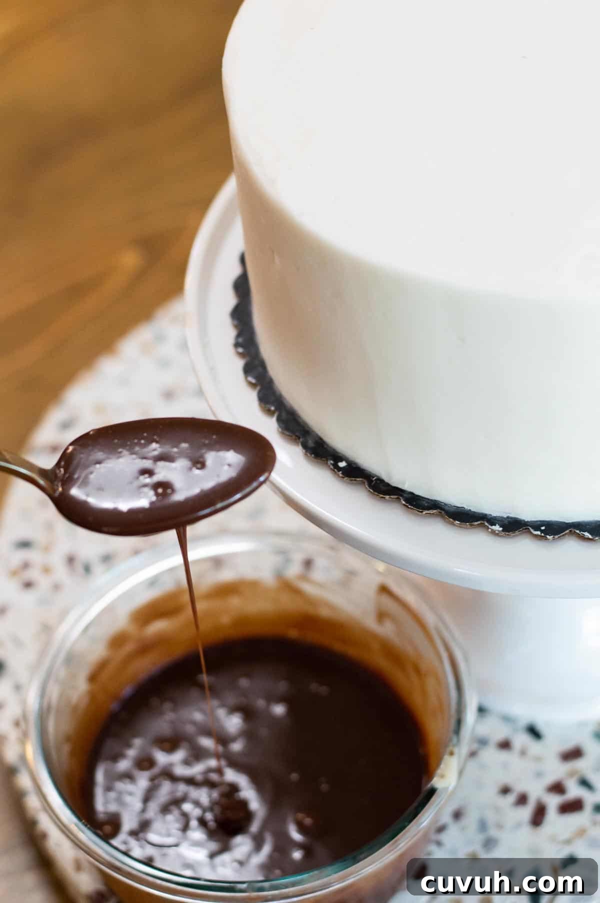 White frosted drip cake with chocolate ganache