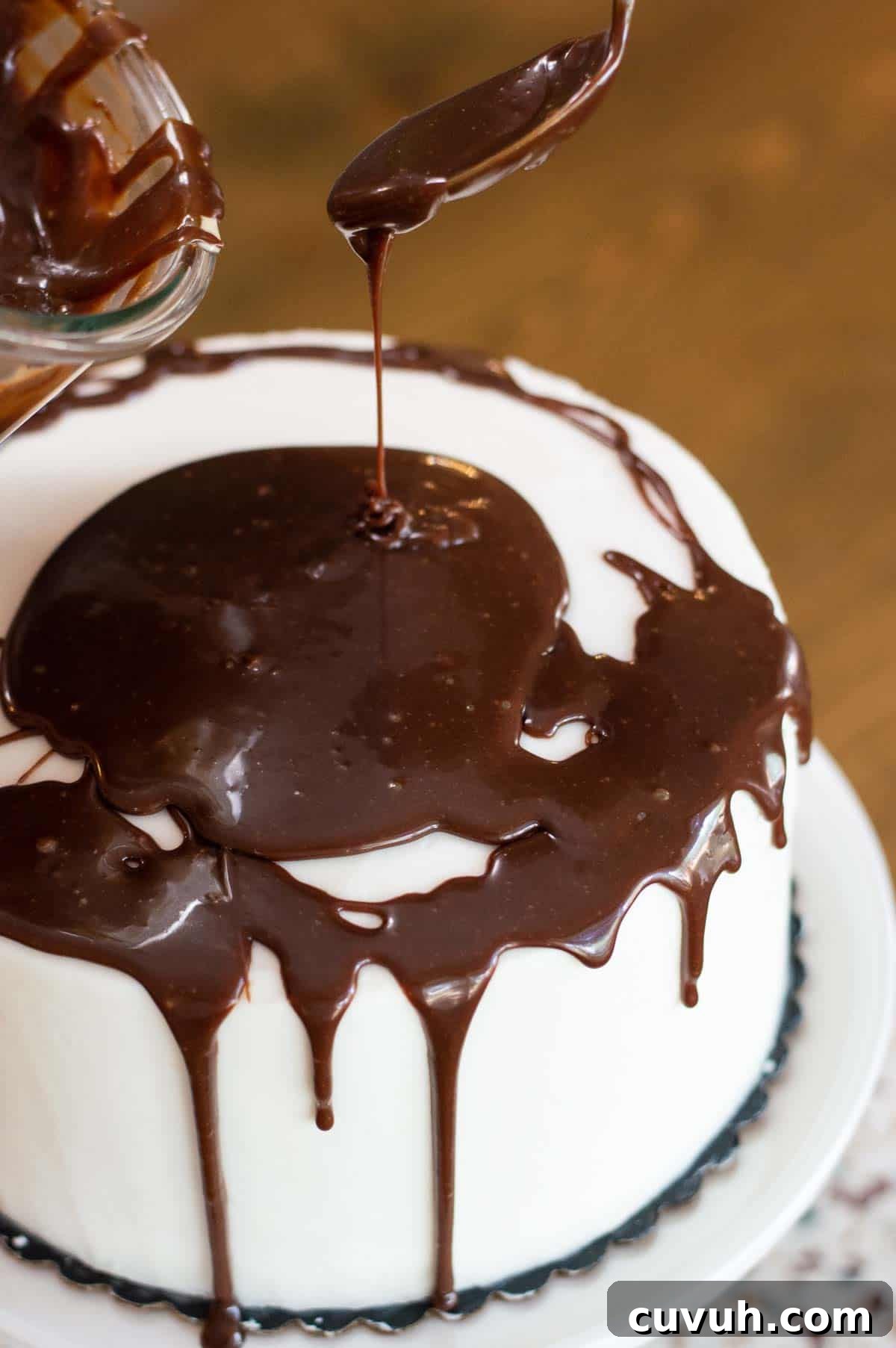 White frosted drip cake with chocolate ganache