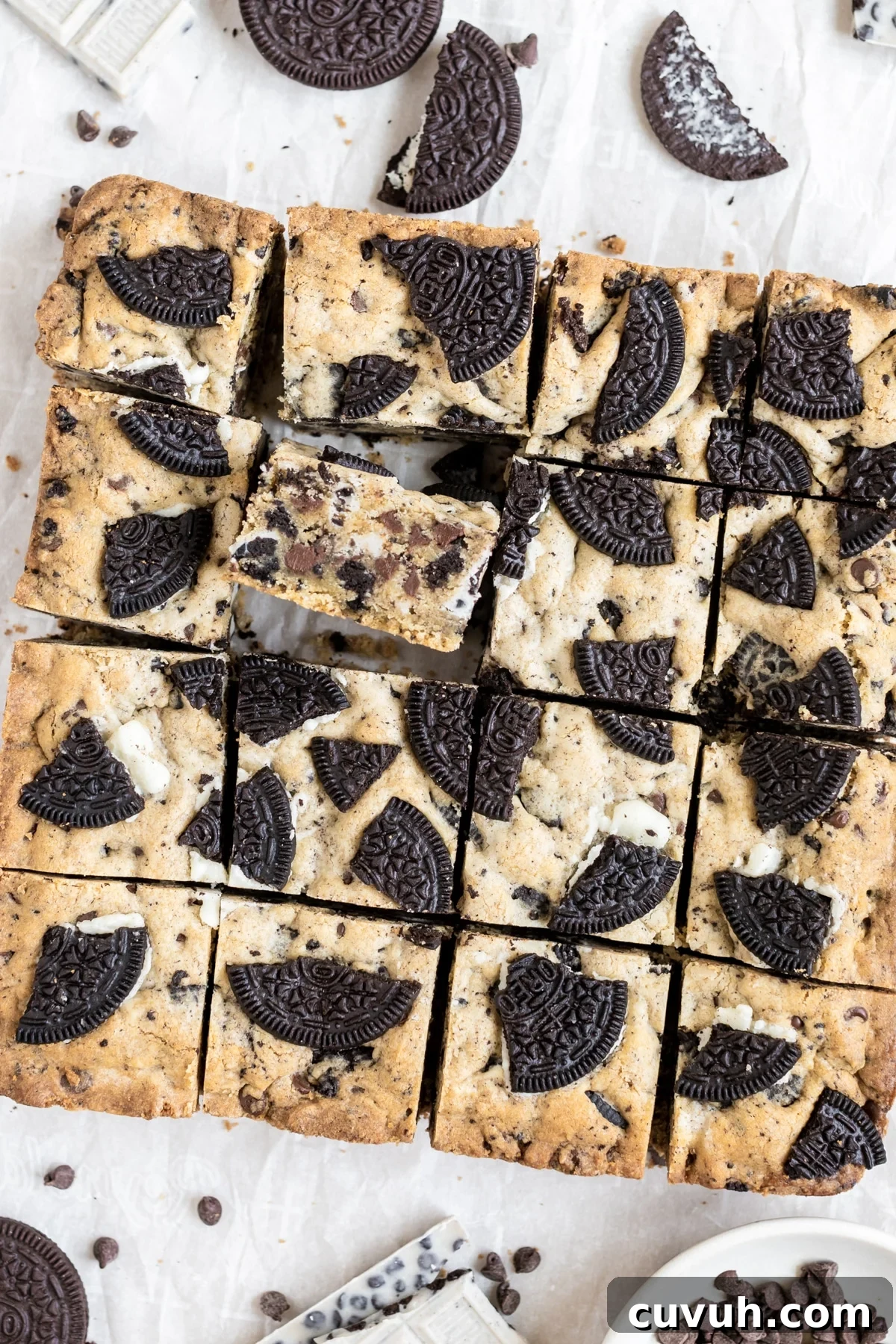 cookies and cream bars on a piece of parchment paper, cut into square bars