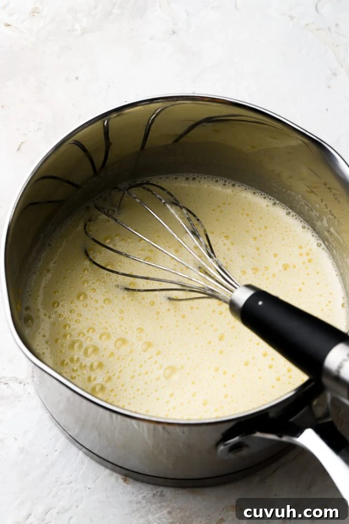 Party-Size Vanilla Birthday Sheet Cake Recipe 18 eggs tempered with milk in saucepan