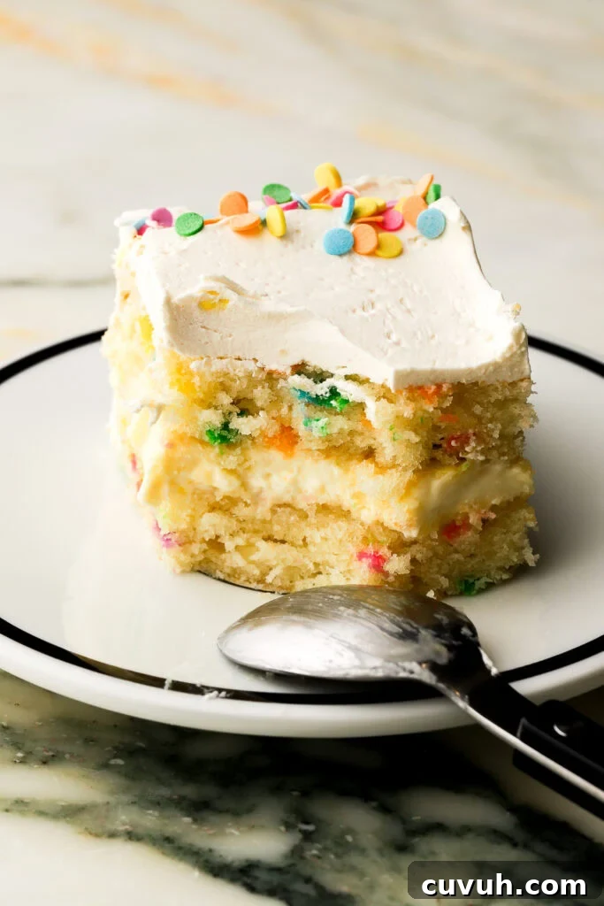 Party-Size Vanilla Birthday Sheet Cake Recipe 3 slice of birthday cake on a plate with a bite taken out and the spoon on the edge