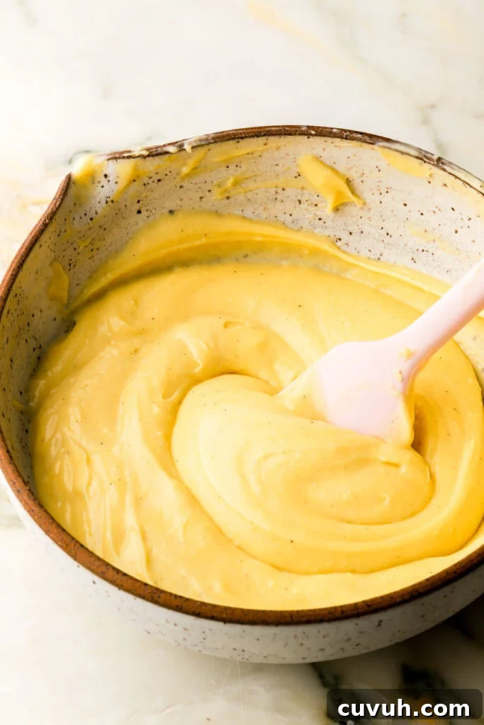 Party-Size Vanilla Birthday Sheet Cake Recipe 21 finished pastry cream in bowl with a spatula